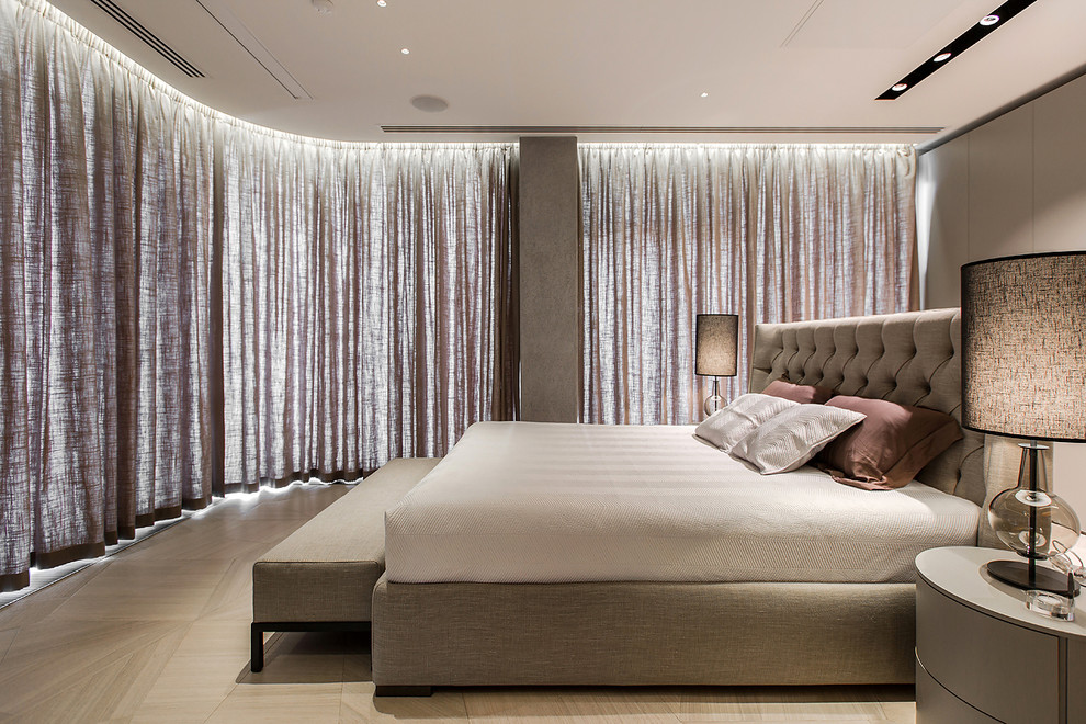 This is an example of a contemporary master bedroom in Moscow with light hardwood flooring.