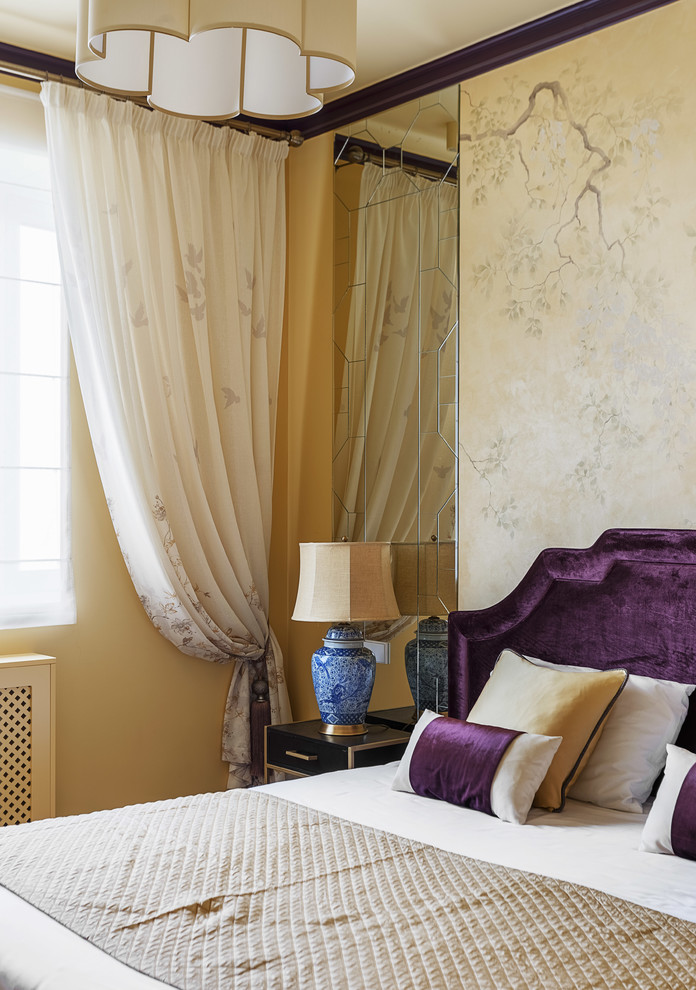 This is an example of a small traditional master bedroom in Moscow with yellow walls.