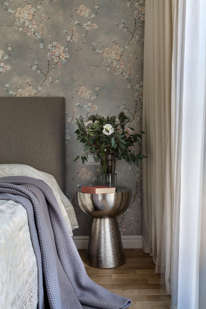 На фото: хозяйская спальня в стиле неоклассика (современная классика) с серыми стенами и полом из ламината с