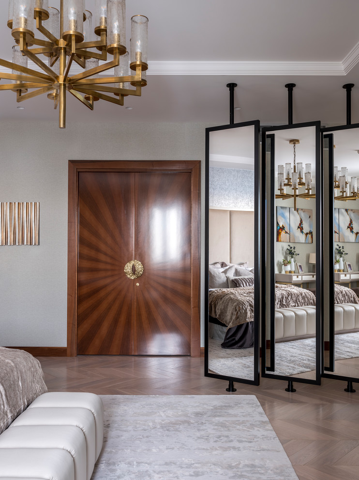 This is an example of a contemporary master bedroom in Moscow with grey walls, light hardwood flooring and beige floors.