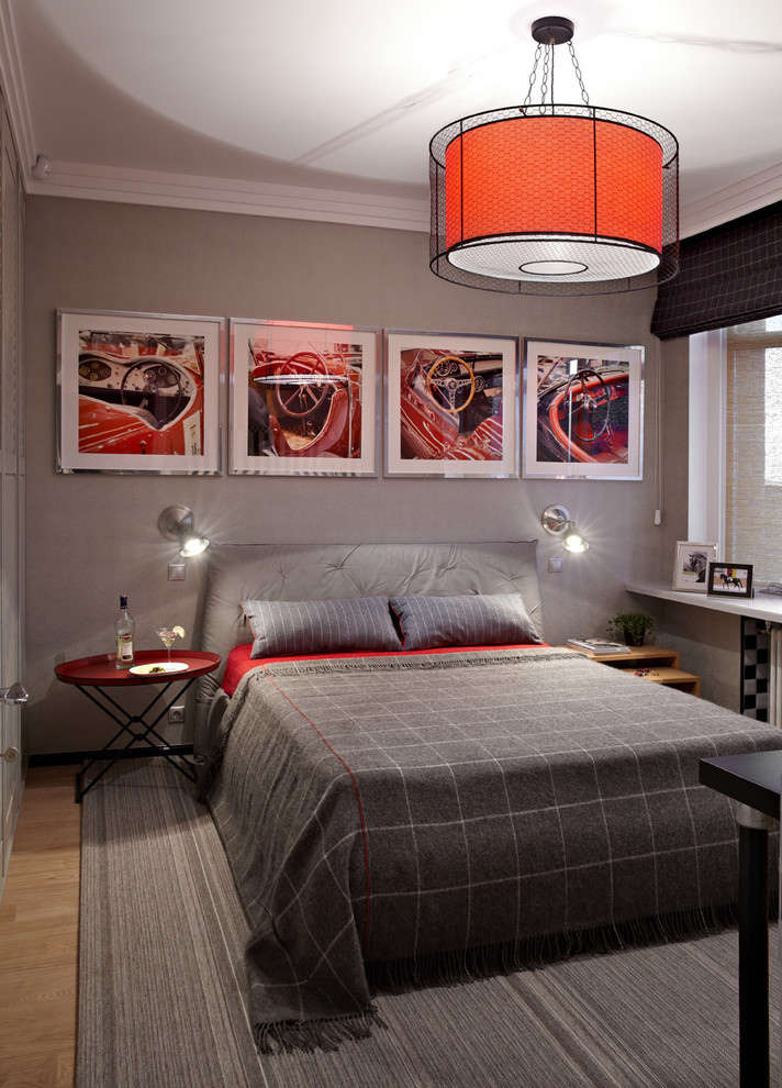 This is an example of a contemporary master bedroom in Moscow with grey walls and light hardwood flooring.