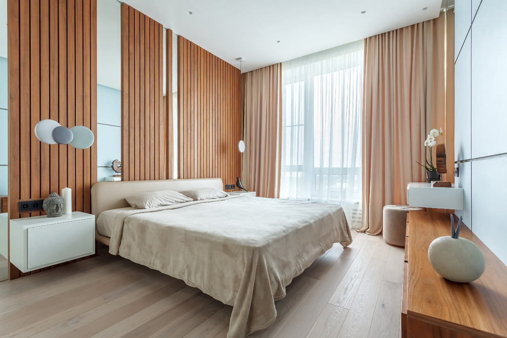 На фото: хозяйская спальня среднего размера в современном стиле с коричневыми стенами, полом из ламината, бежевым полом и тюлем без камина с