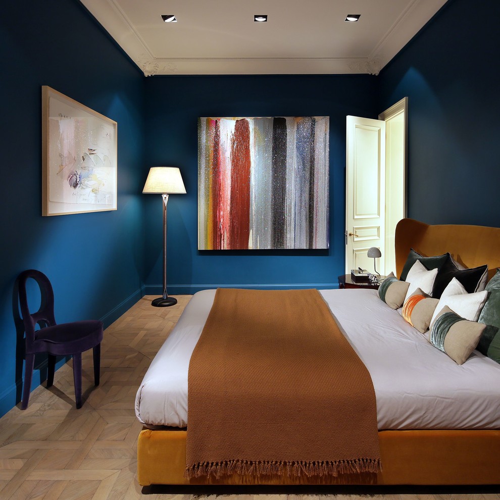 Réalisation d'une chambre bohème avec un mur bleu, parquet clair et un sol beige.