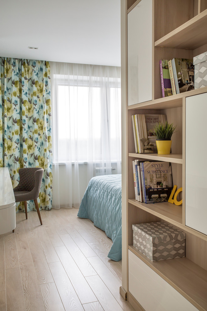 Cette photo montre une chambre parentale tendance de taille moyenne avec un mur beige et parquet clair.