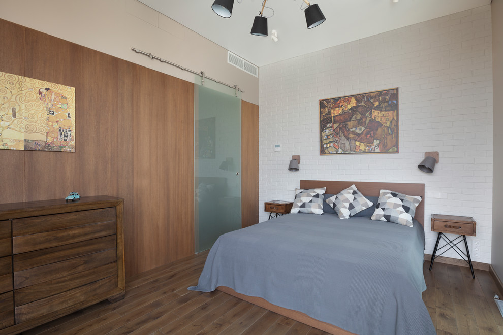 Photo of a medium sized contemporary master bedroom in Moscow with white walls, medium hardwood flooring and brown floors.