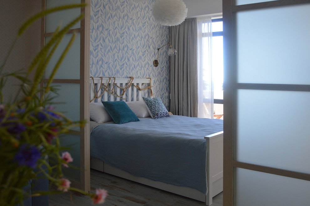 This is an example of a small beach style master bedroom in Other with multi-coloured walls, porcelain flooring and turquoise floors.