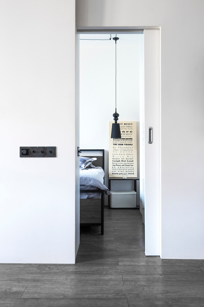 Réalisation d'une petite chambre parentale design avec un mur blanc, un sol en vinyl et un sol marron.