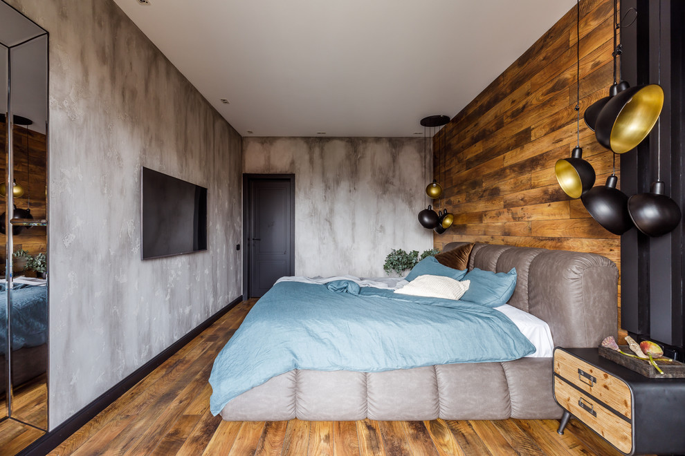 На фото: хозяйская спальня в скандинавском стиле с серыми стенами и паркетным полом среднего тона с