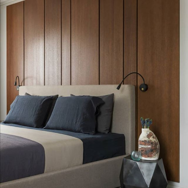 На фото: хозяйская спальня в современном стиле с серыми стенами и панелями на части стены с