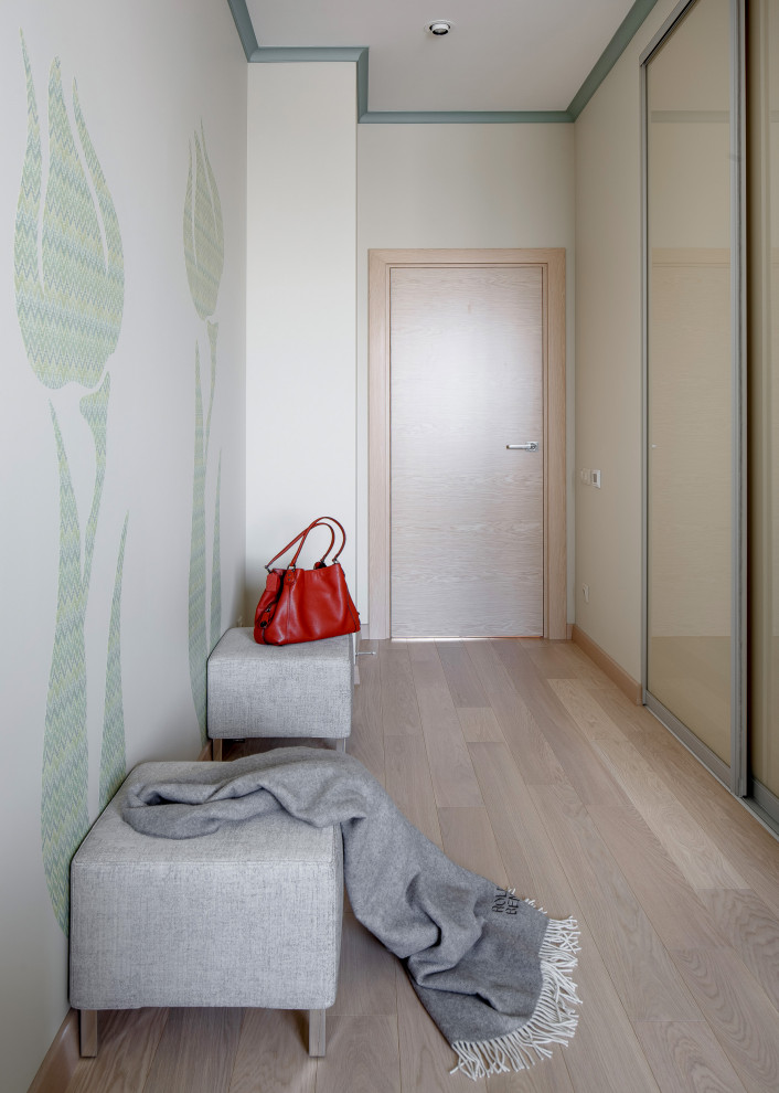 Modelo de dormitorio principal contemporáneo de tamaño medio con paredes verdes y suelo de madera en tonos medios