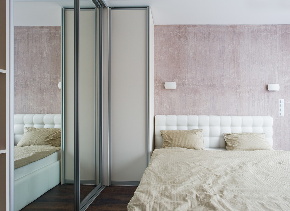 Photo of a small contemporary master bedroom in Saint Petersburg with pink walls, laminate floors and brown floors.