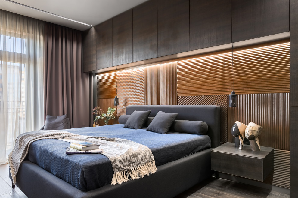 Идея дизайна: хозяйская спальня среднего размера в современном стиле с полом из ламината, коричневым полом, коричневыми стенами и кроватью в нише