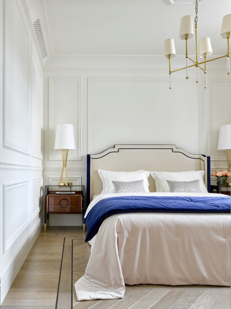Example of a transitional master light wood floor and wainscoting bedroom design in Moscow with white walls