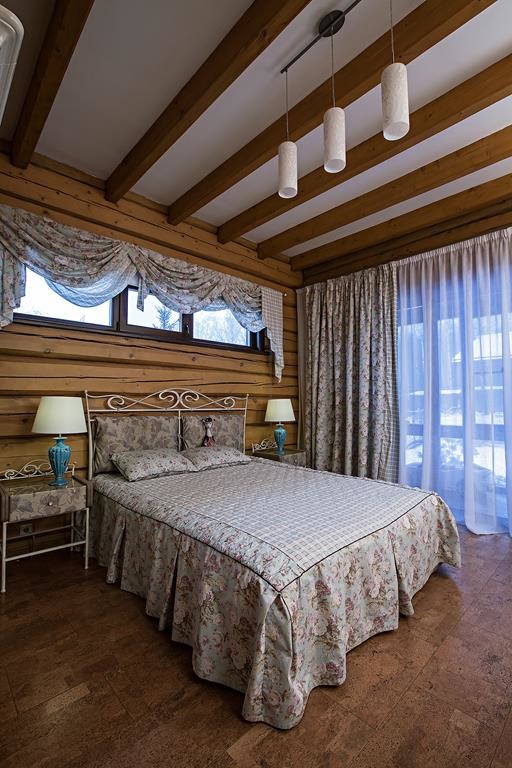 Diseño de dormitorio principal campestre grande con paredes beige, suelo de corcho y suelo marrón