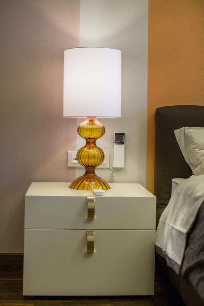 Свежая идея для дизайна: хозяйская спальня среднего размера в современном стиле с оранжевыми стенами, темным паркетным полом и коричневым полом - отличное фото интерьера