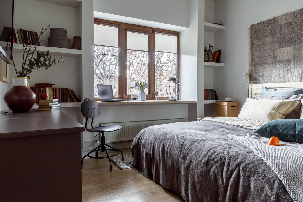 This is an example of a contemporary master bedroom in Other with light hardwood flooring, no fireplace and white walls.