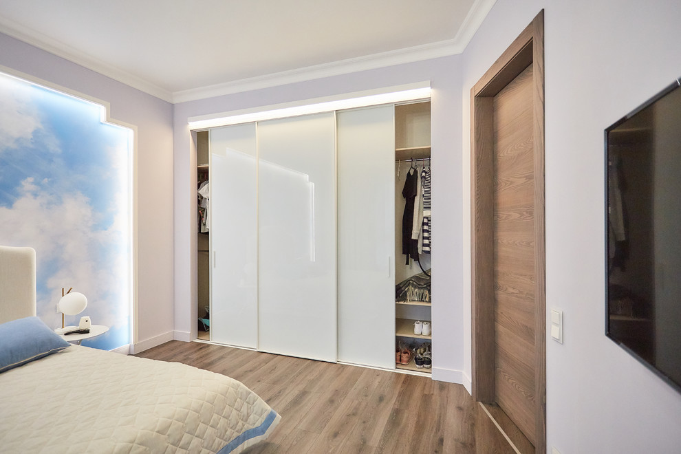 This is an example of a medium sized scandi bedroom in Moscow.