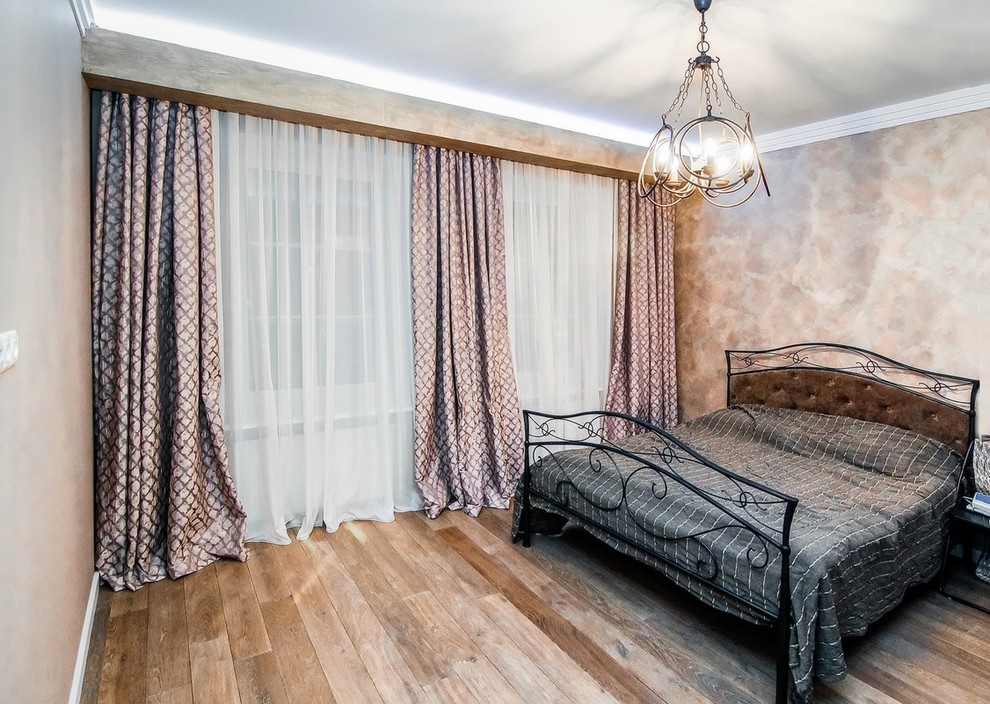 Diseño de habitación de invitados industrial de tamaño medio con paredes rosas, suelo de madera en tonos medios y suelo marrón