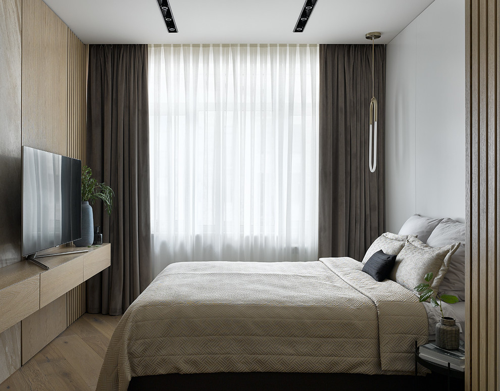 Photo of a contemporary master bedroom in Moscow with white walls, light hardwood flooring and beige floors.