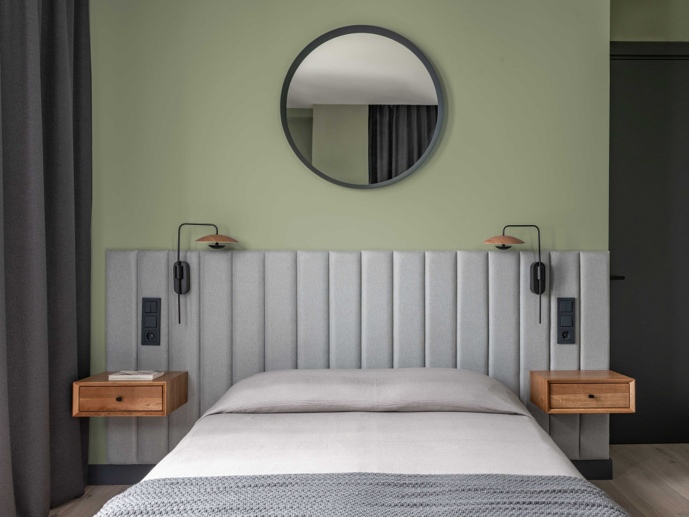 Photo of a medium sized scandi bedroom in Moscow with green walls, light hardwood flooring and grey floors.