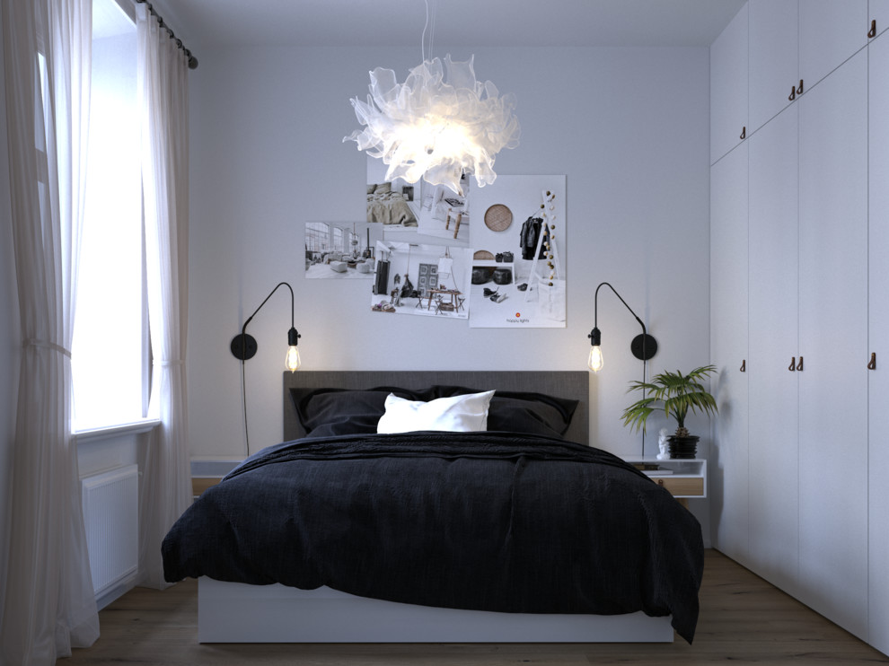 Diseño de dormitorio principal nórdico pequeño con paredes blancas, suelo de madera en tonos medios y suelo marrón