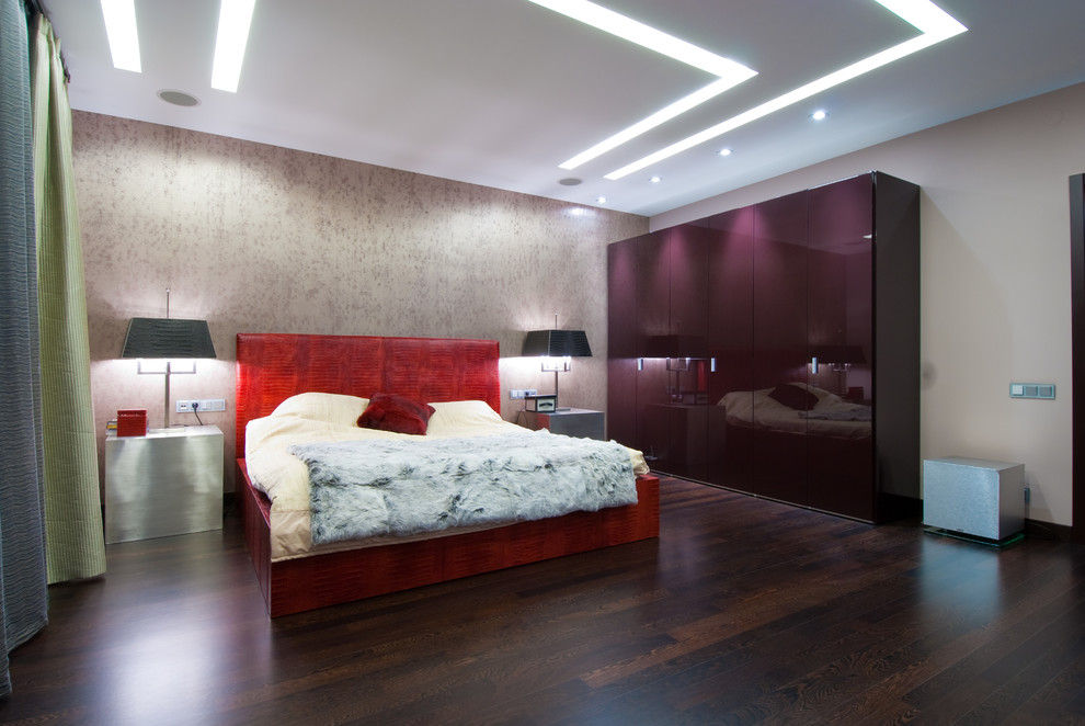 Imagen de dormitorio principal contemporáneo grande con paredes grises y suelo de madera oscura