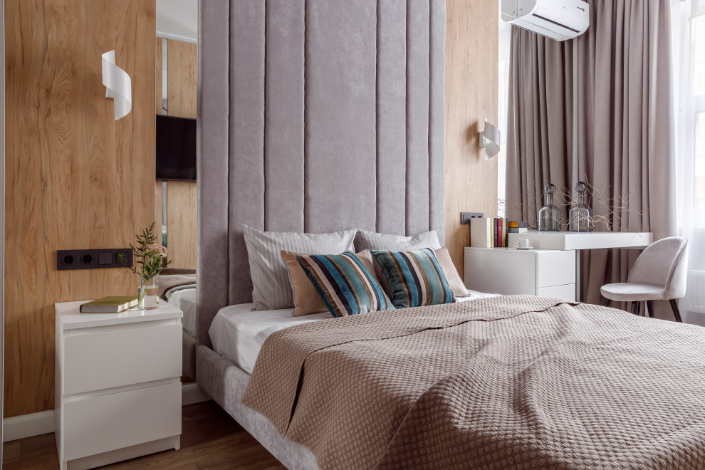 This is an example of a large contemporary master and grey and brown bedroom in Other with white walls and brown floors.
