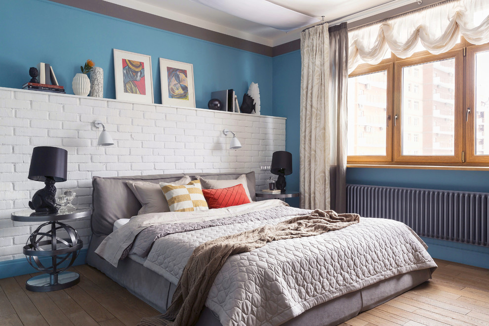 Стильный дизайн: спальня в современном стиле с деревянным полом, коричневым полом и синими стенами - последний тренд