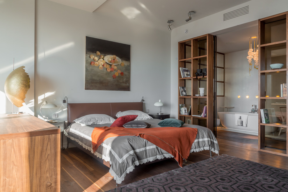 Стильный дизайн: хозяйская спальня в современном стиле с белыми стенами и темным паркетным полом без камина - последний тренд