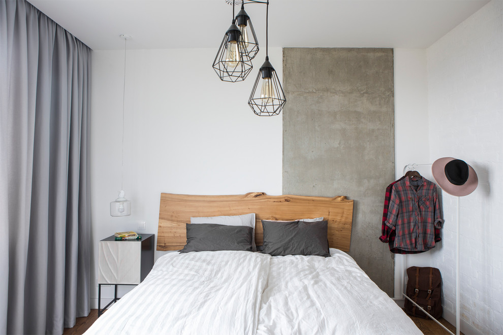 Photo of an industrial master bedroom in Moscow with white walls.