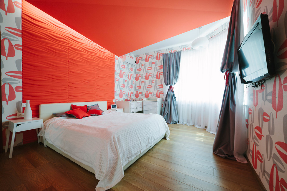 Foto de dormitorio principal grande sin chimenea con paredes rojas y suelo de madera en tonos medios