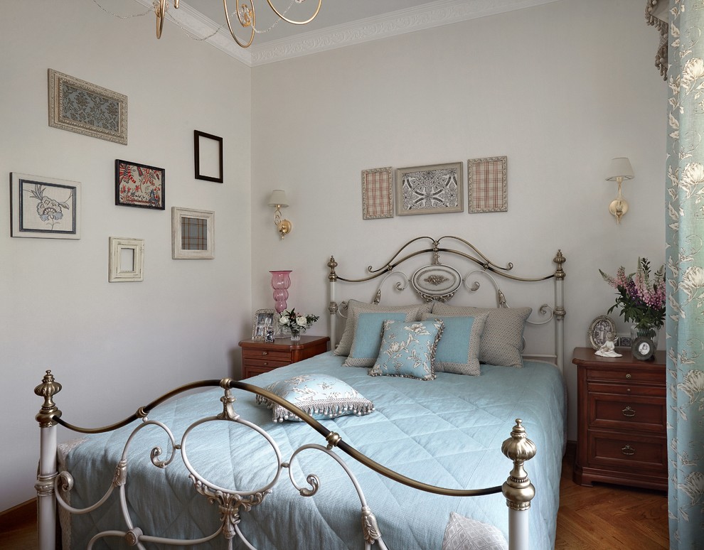 Imagen de dormitorio tradicional con paredes blancas y suelo de madera en tonos medios