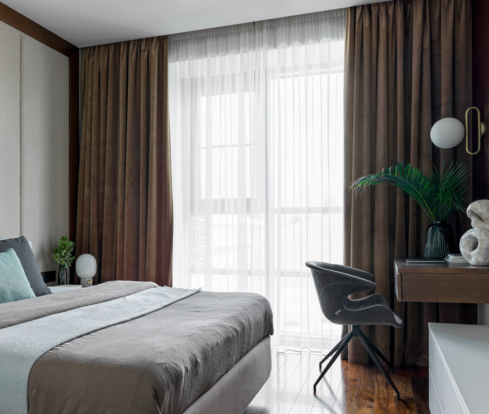 На фото: хозяйская спальня среднего размера в современном стиле с бежевыми стенами, паркетным полом среднего тона и коричневым полом с