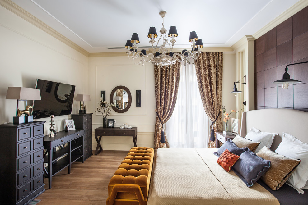 Inspiration for a traditional master bedroom in Moscow with beige walls, medium hardwood flooring and brown floors.