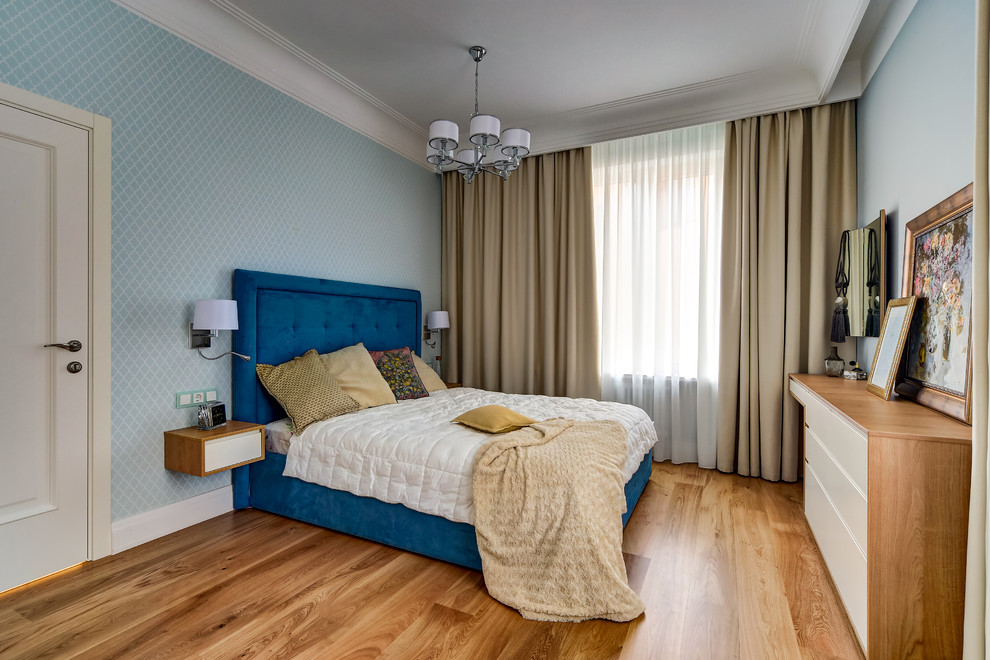 Inspiration for a coastal master bedroom in Saint Petersburg with blue walls, medium hardwood flooring and beige floors.
