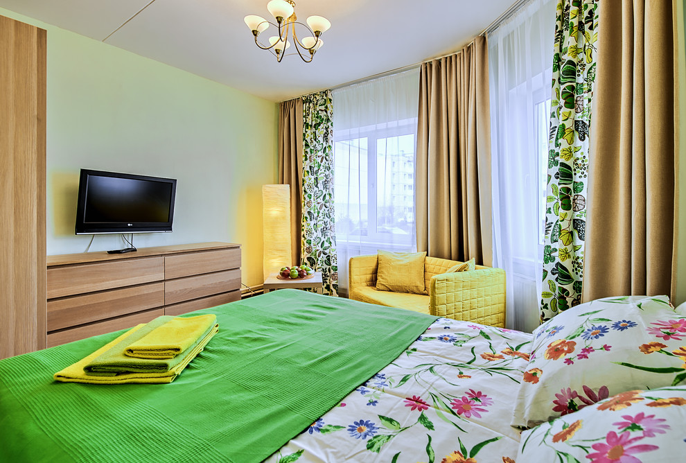 Photo of a small contemporary master bedroom in Saint Petersburg with green walls, laminate floors and no fireplace.