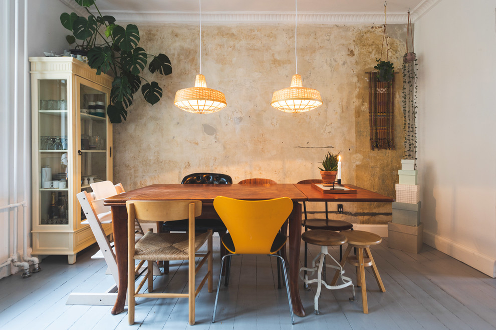 Bohemian dining room in Copenhagen with beige walls, painted wood flooring and grey floors.