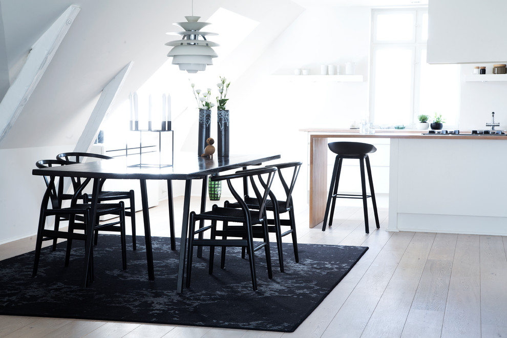 Scandinavian kitchen/dining room in Copenhagen with white walls and white floors.