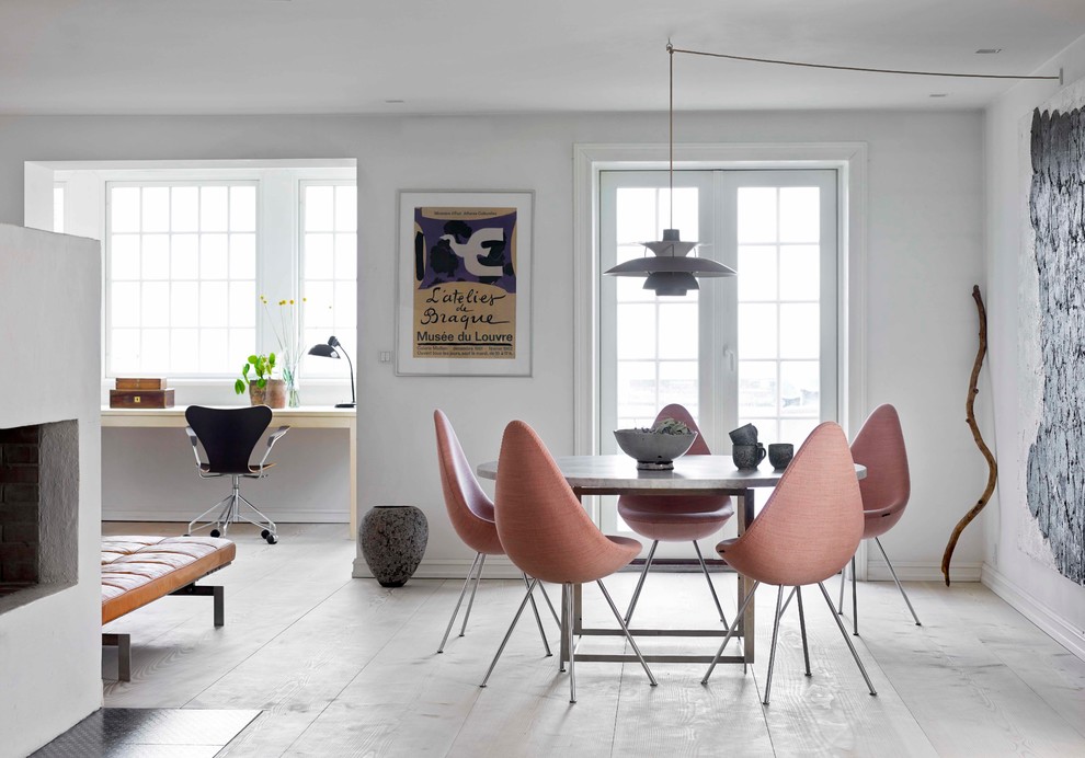 Mid-sized danish light wood floor dining room photo in Copenhagen with white walls