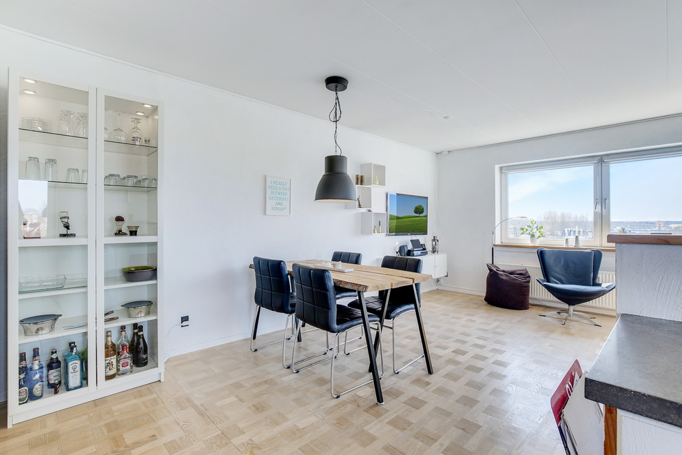 This is an example of a medium sized scandi dining room in Aalborg with white walls, light hardwood flooring, no fireplace and beige floors.