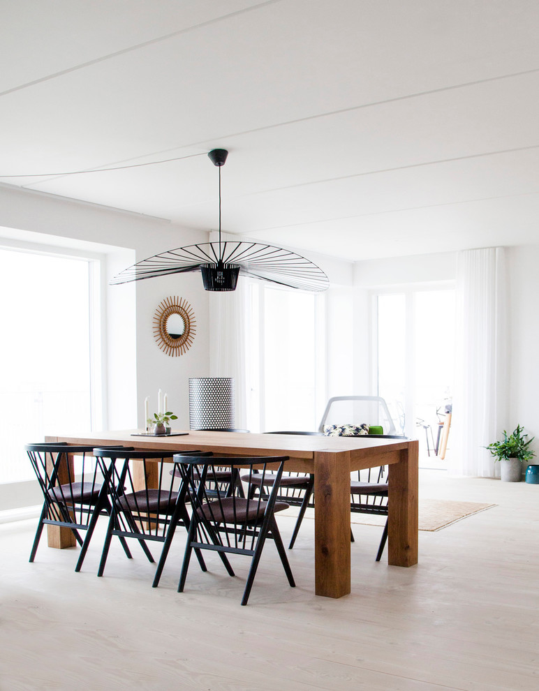 Medium sized scandi dining room in Copenhagen with white walls, light hardwood flooring and beige floors.