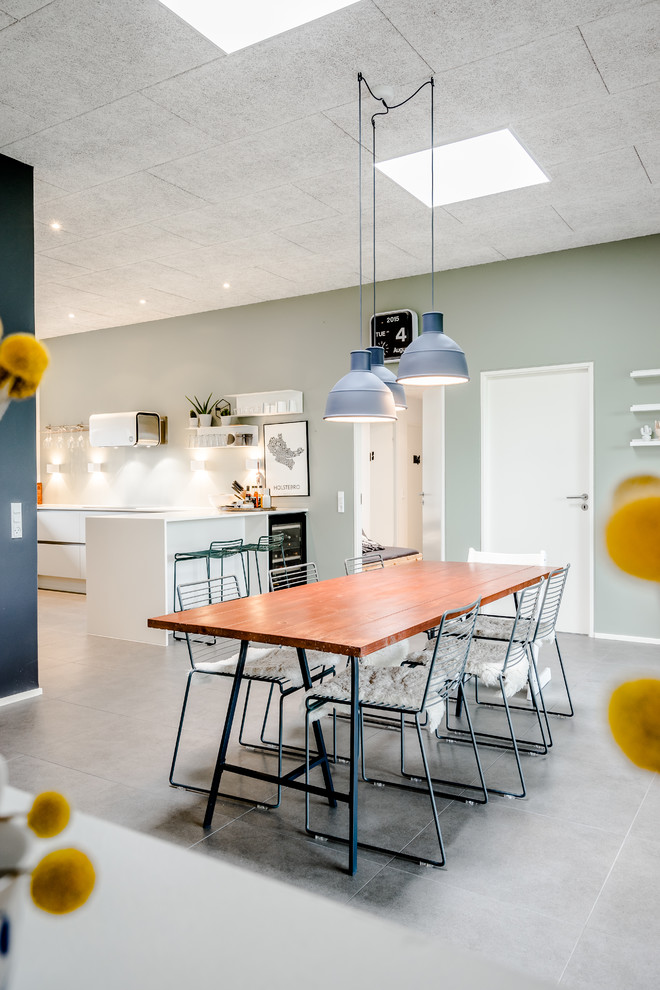 This is an example of a scandinavian open plan dining room in Esbjerg with green walls and no fireplace.