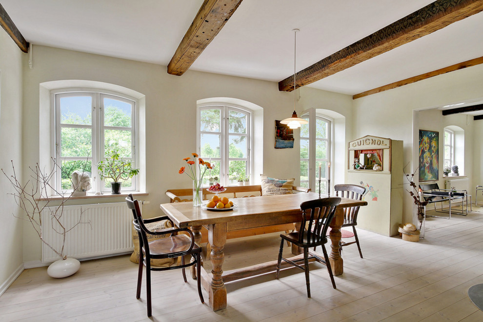 Example of a mid-sized cottage light wood floor great room design in Esbjerg with white walls and no fireplace