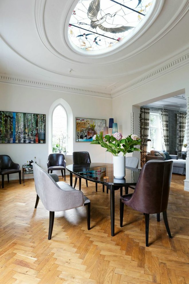 Dining room - scandinavian medium tone wood floor and brown floor dining room idea in Copenhagen with white walls