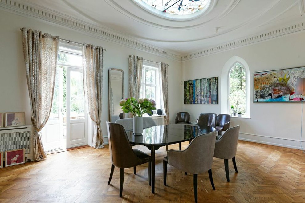 Design ideas for a large modern dining room in Copenhagen with white walls and brown floors.