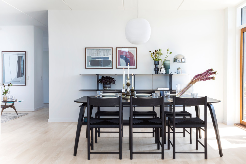 Photo of a scandi dining room in Copenhagen with white walls, light hardwood flooring and beige floors.