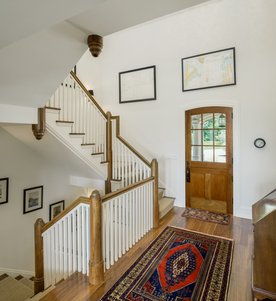 Inspiration for a large coastal carpeted curved staircase in Providence with wood risers.