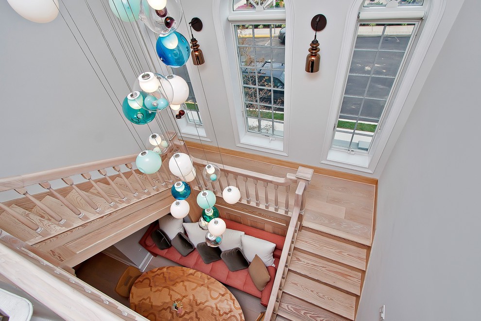 Design ideas for a large nautical wood u-shaped staircase in New York with wood risers.