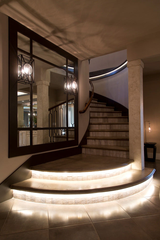 Inspiration for a large transitional concrete curved staircase remodel in Kansas City with tile risers