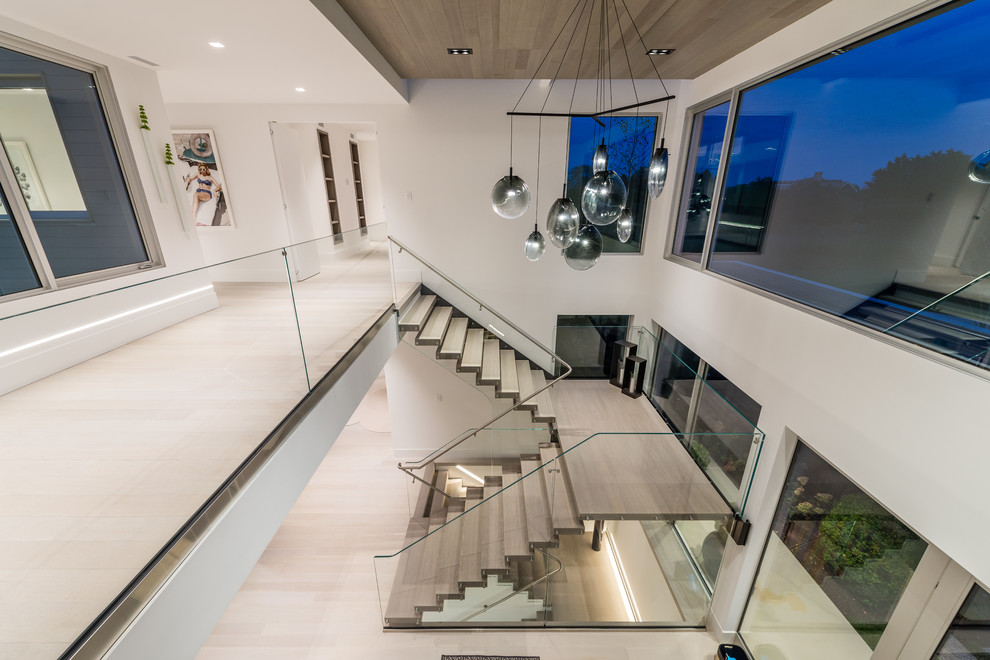 Photo of an expansive contemporary u-shaped glass railing staircase in New York.